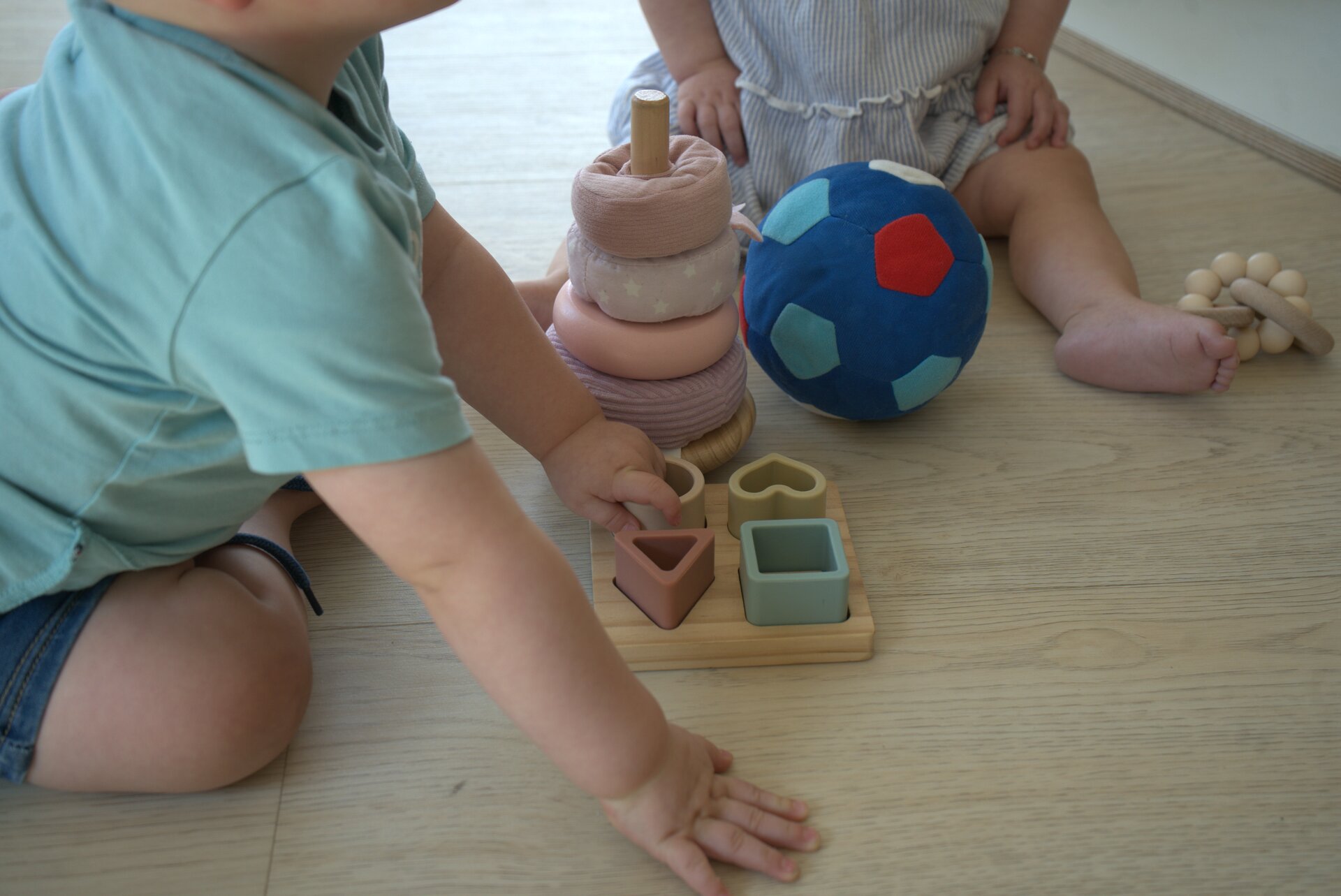 Peuters spelen met stapeltoren en zachte bal